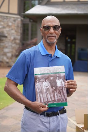 Pete McDaniel holding a copy of Uneven Lies.