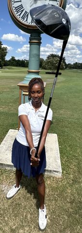 A golfer holding a TaylorMade driver on the course.