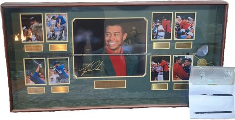 Framed display with a King Cobra driver and photographs of Tiger Woods at the 1997 Masters.